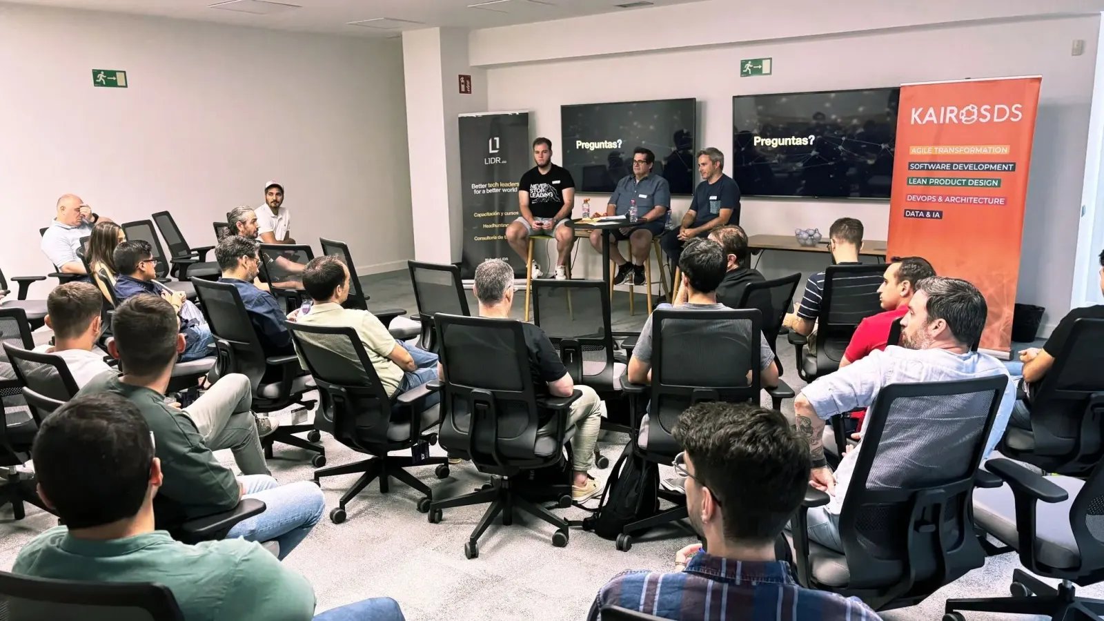 Daniel Gil speaking on a panel discussion in front of an audience of developers